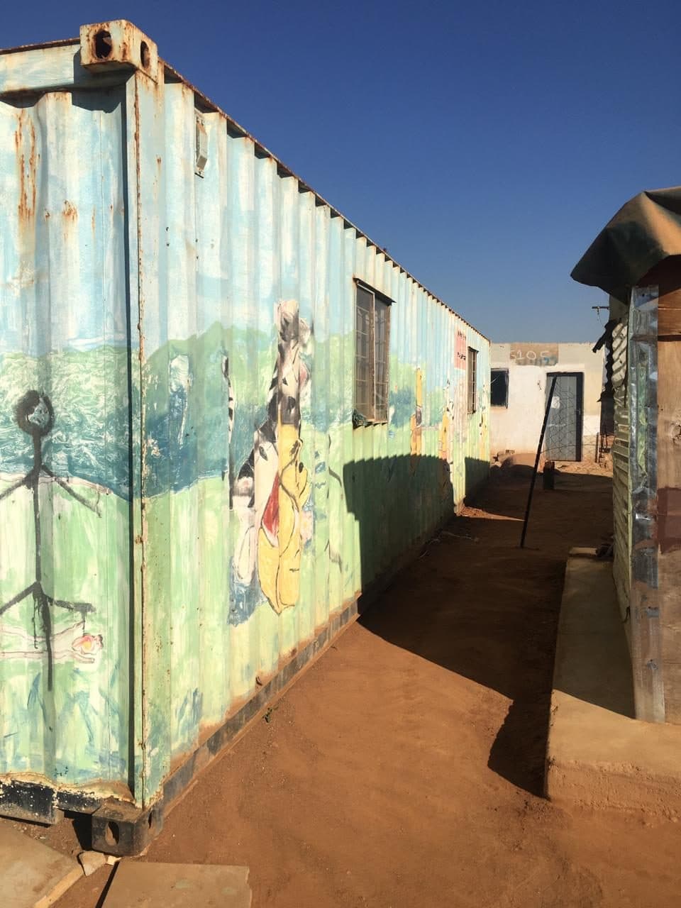 A row of painted container homes in Kaalfontein