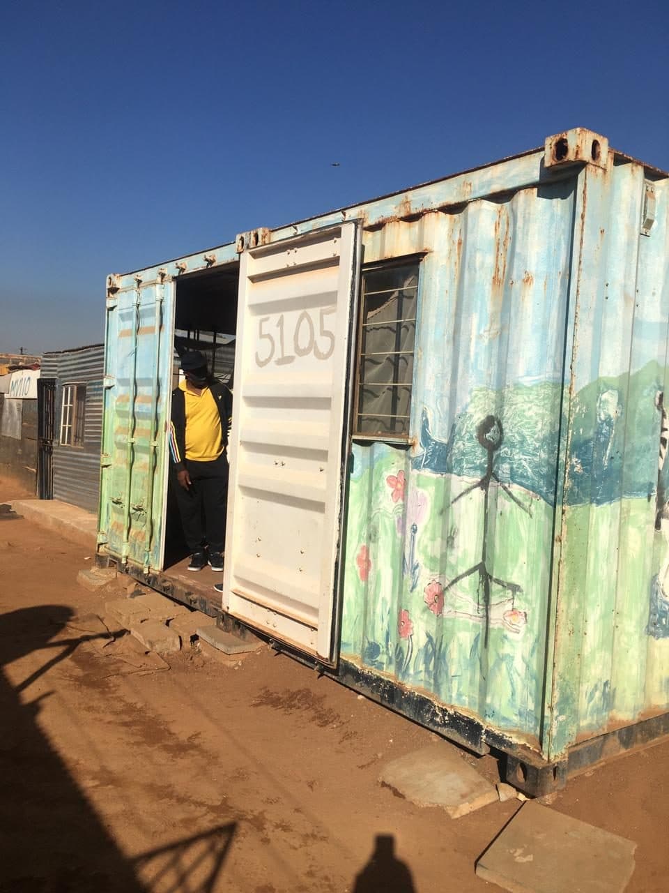 A painted container home in Kaalfontein that HVT wired and connected to power