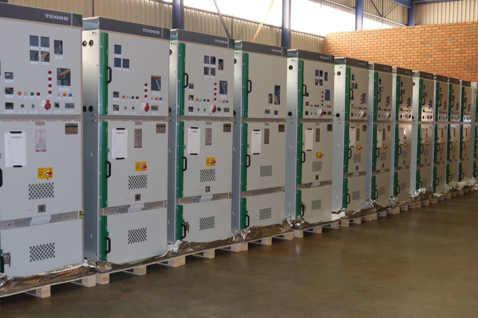 A long line-up of medium-voltage switchgear panels inside a building